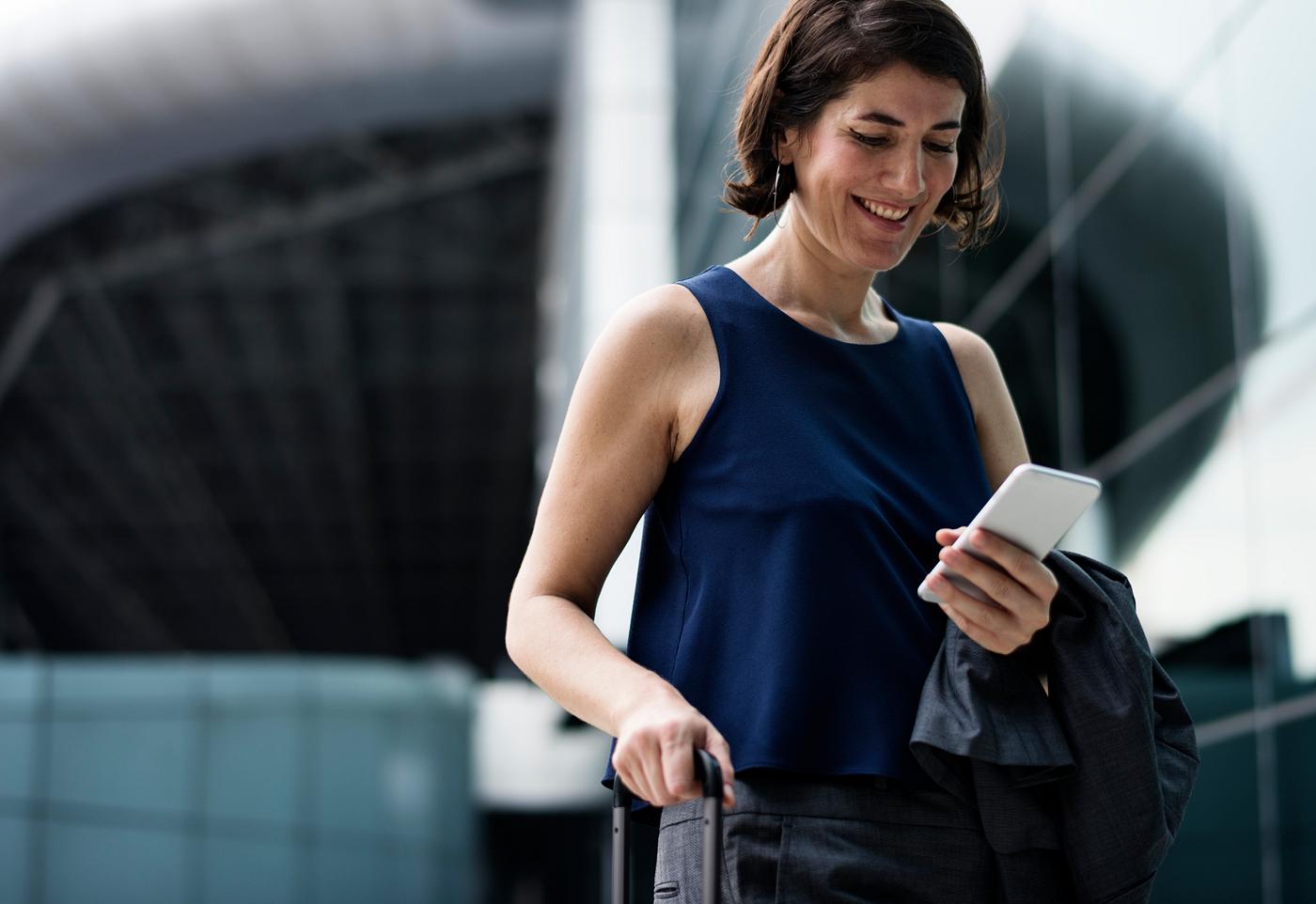 Smiling businesswoman using her phone Smiling businesswoman using her phone