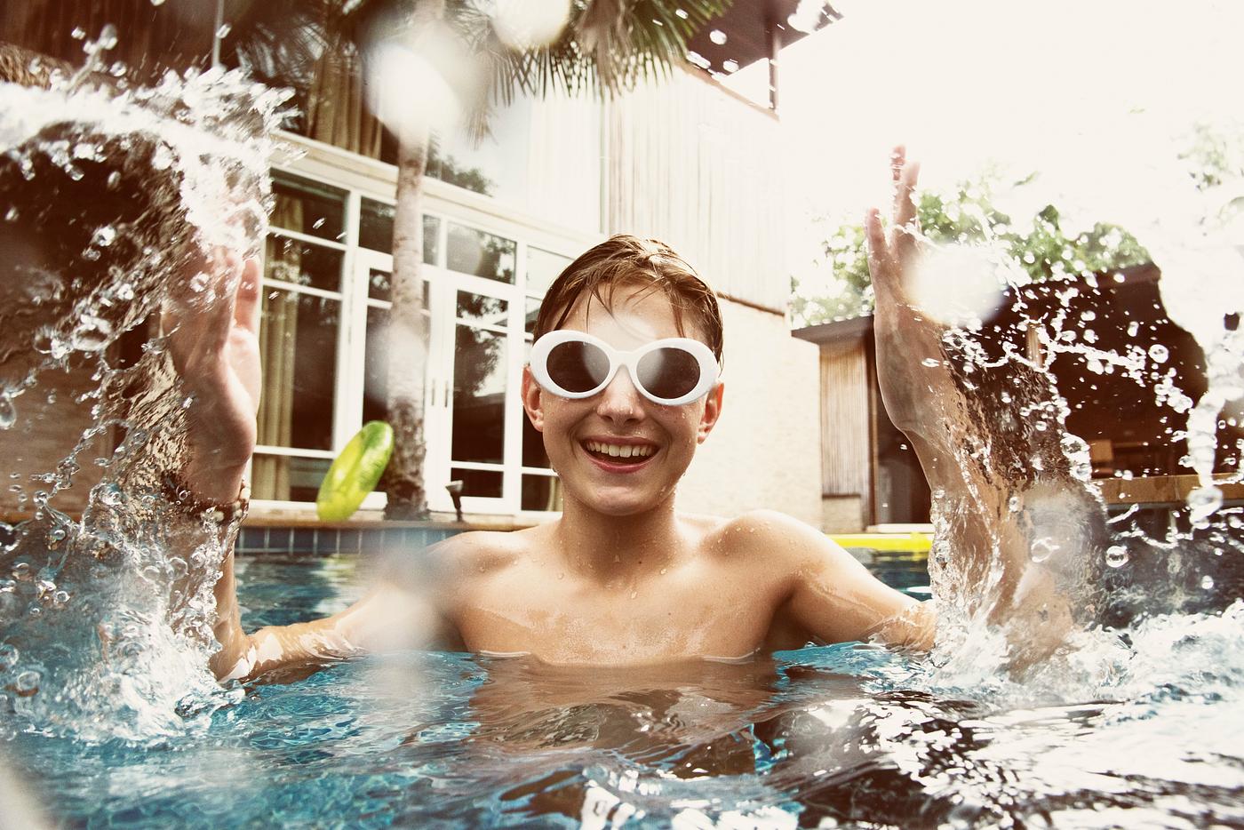 Teenage boy having fun in swimming pool Teenage boy having fun in swimming pool