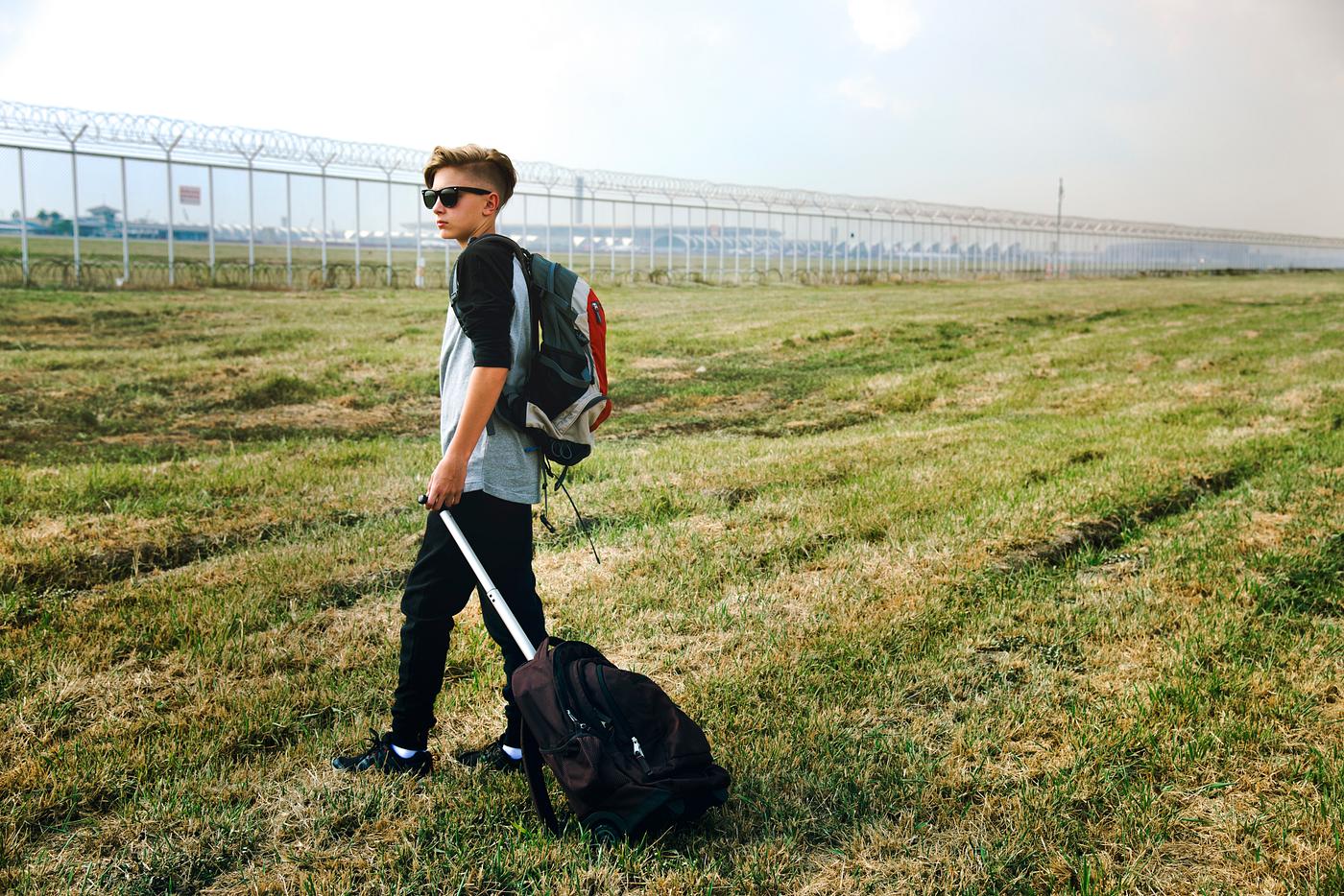 Young caucasian man travel with luggage outdoors Young caucasian man travel with luggage outdoors