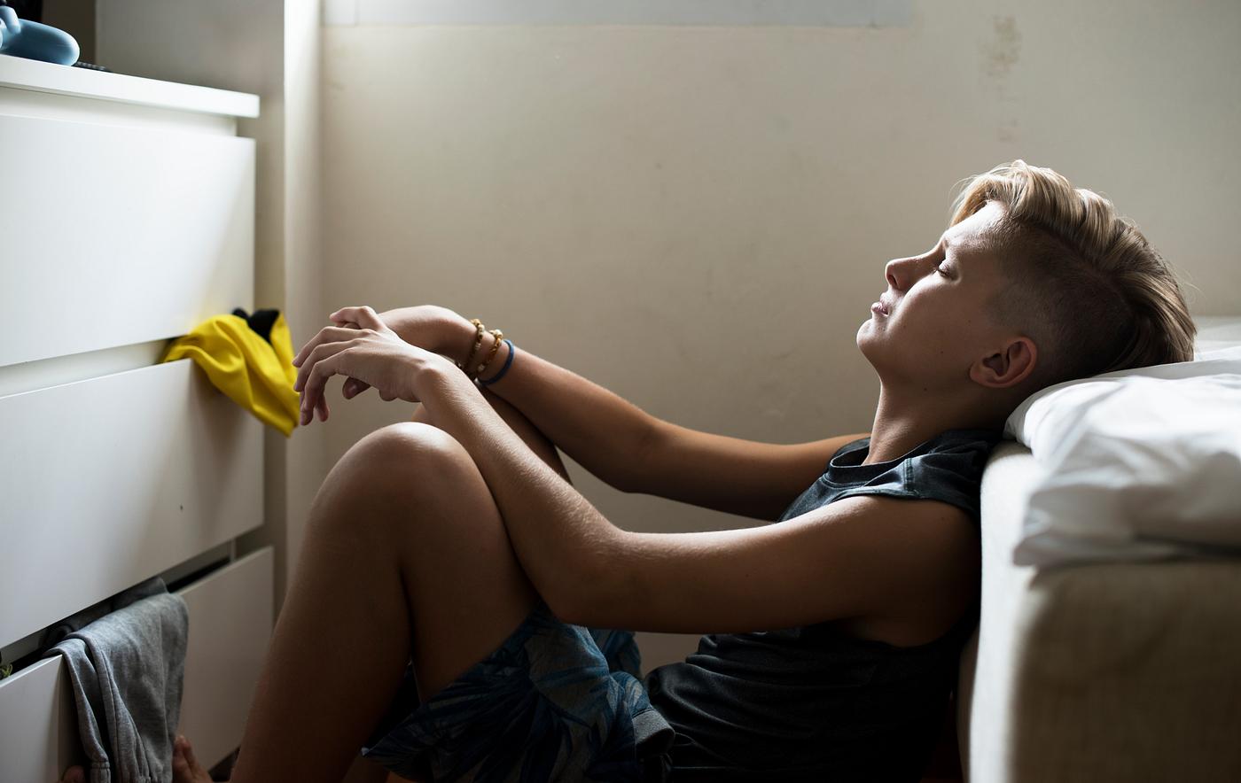 Closeup of young caucasian man sitting with face express of depressed upset emotion - depression, sad, adolescence, alone,... Closeup of young caucasian man sitting with face express of depressed upset emotion - depression, sad, adolescence, alone,...