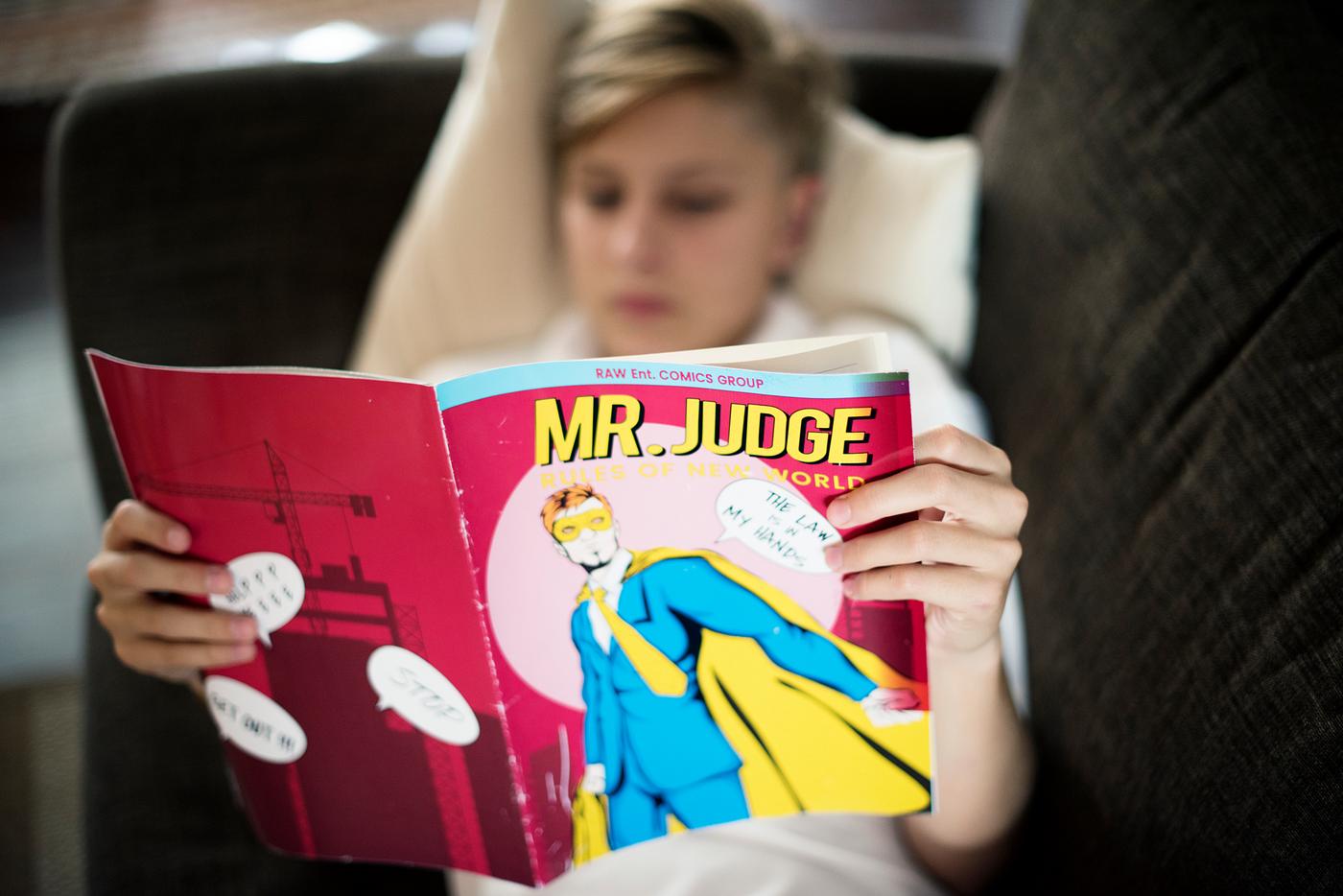 Young caucasian man lying on the couch reading comics - adolescence, alone, boy, cartoon, closeup, couch, enjoying, home,... Young caucasian man lying on the couch reading comics - adolescence, alone, boy, cartoon, closeup, couch, enjoying, home,...