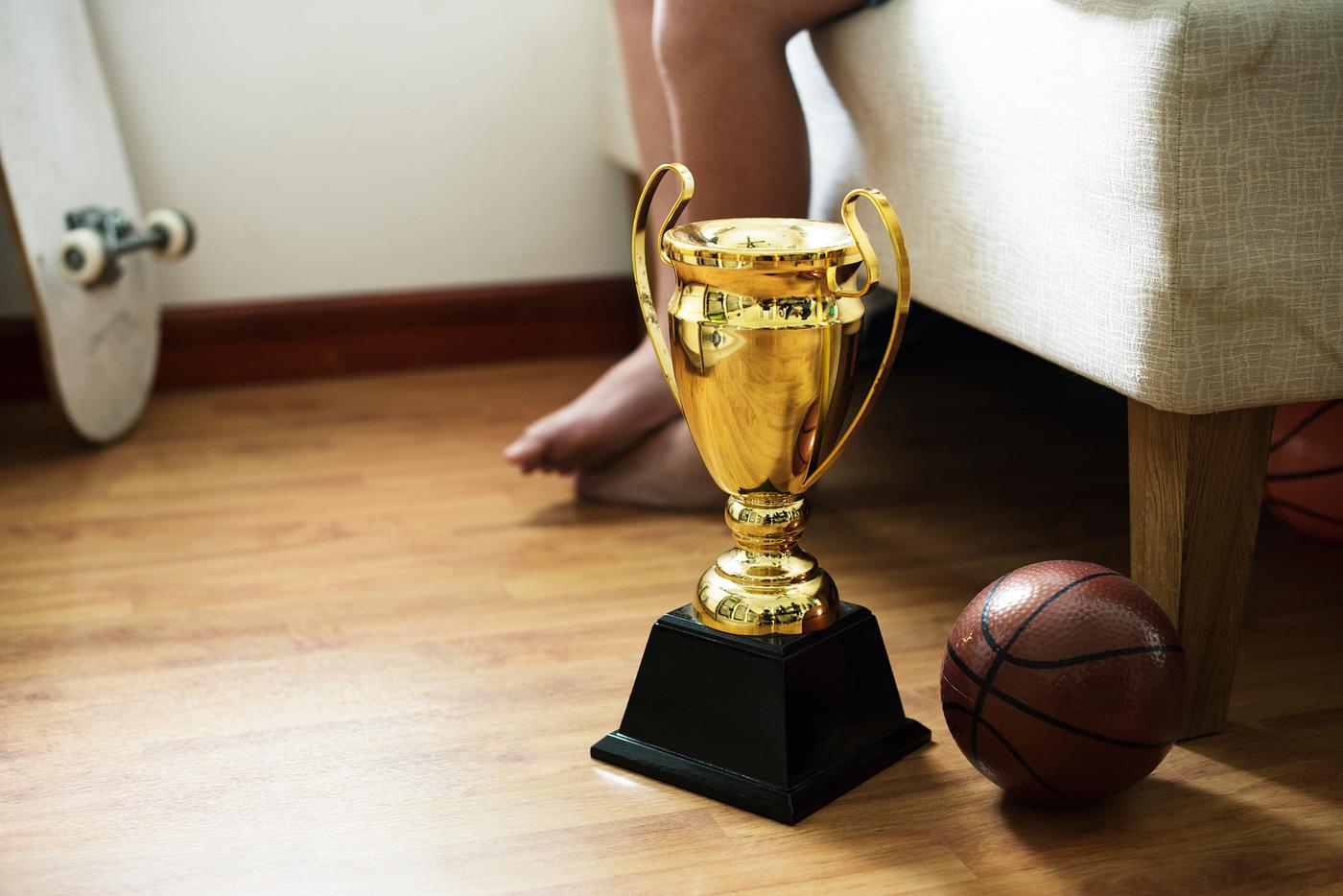 Closeup of trophy on the bedroom floor with basketball Closeup of trophy on the bedroom floor with basketball