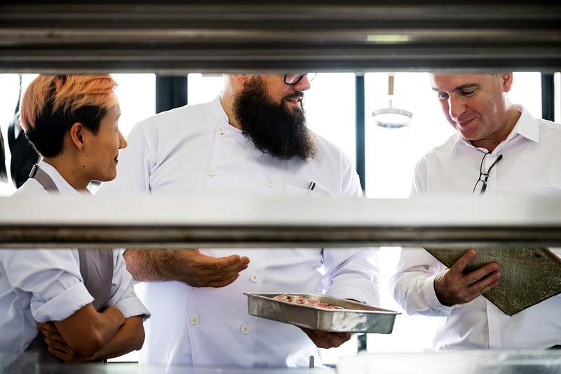 10 Essential Restaurant Manager Traits That Makes Them Exceptional 1 Restaurant manager checking food quality in the kitchen