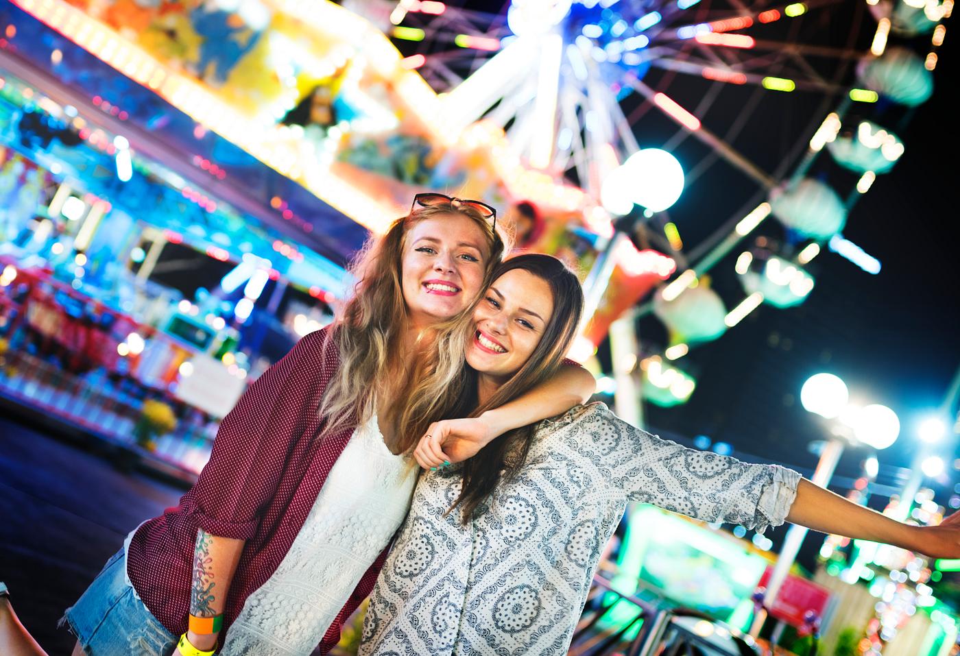 A group of friends is enjoying the amusement park A group of friends is enjoying the amusement park