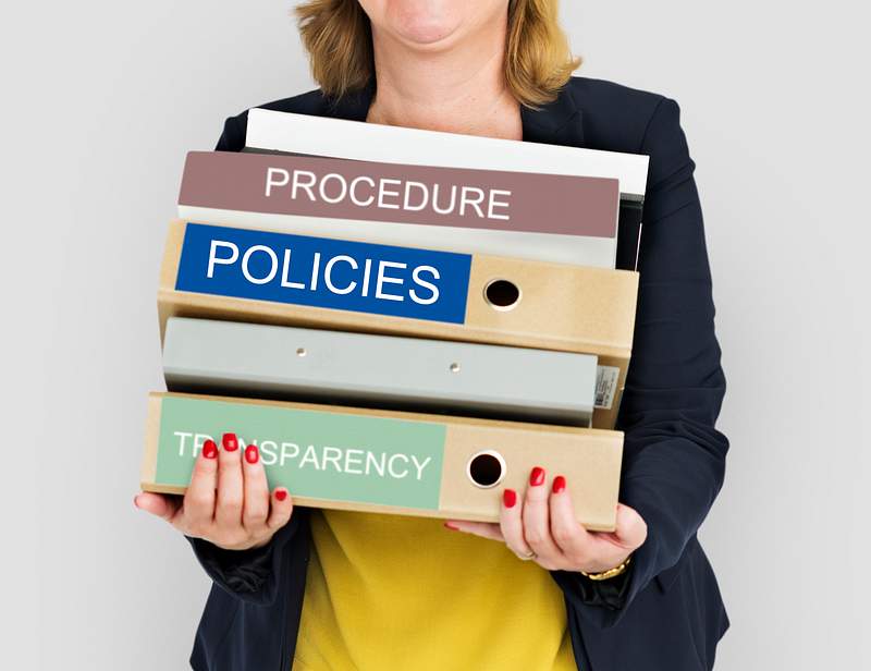 Restaurant Employee Handbook | Know The 8 Elements Of A Helpful Employee Handbook 1 Office woman carrying a bunch of folders