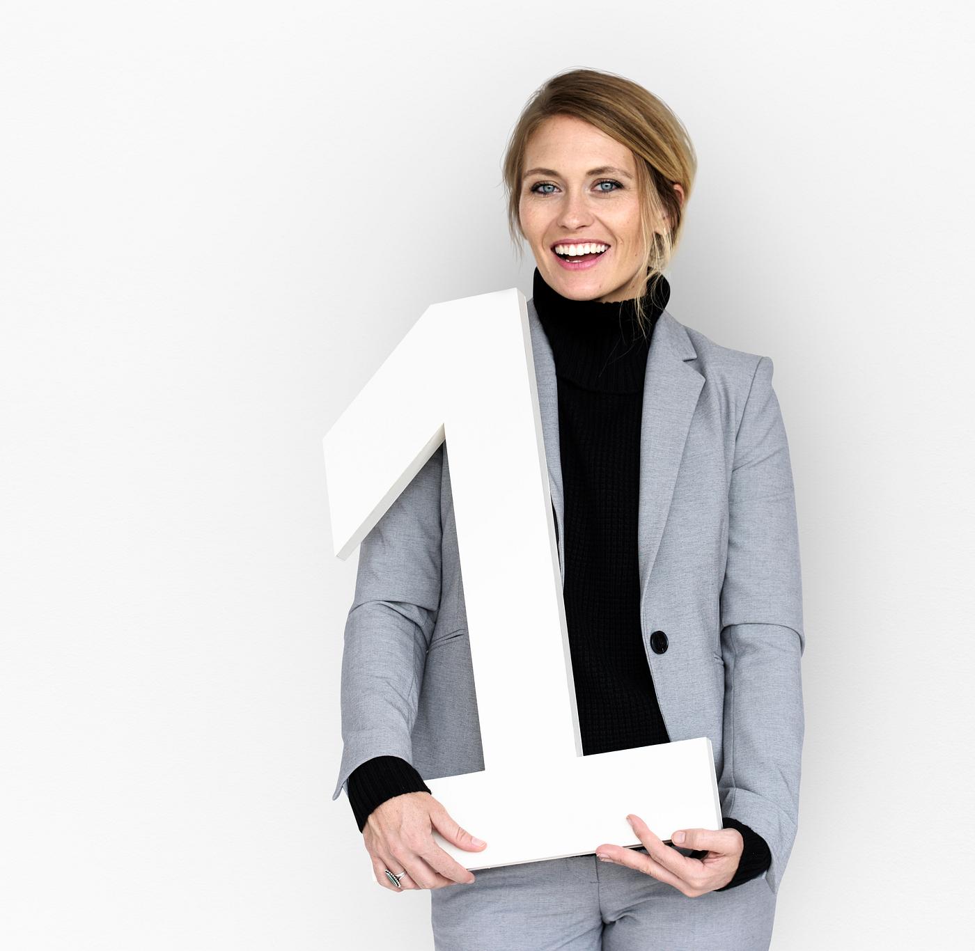 isolated on white, one, woman, suit, number, number one, smiling, hold, smile, happy, prop isolated on white, one, woman, suit, number, number one, smiling, hold, smile, happy, prop