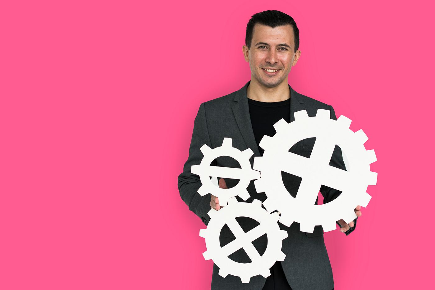 studio, progress, expression, person, holding, people, teamwork, gear, pink, smile, cheerful, smiling, isolated, connection... studio, progress, expression, person, holding, people, teamwork, gear, pink, smile, cheerful, smiling, isolated, connection...