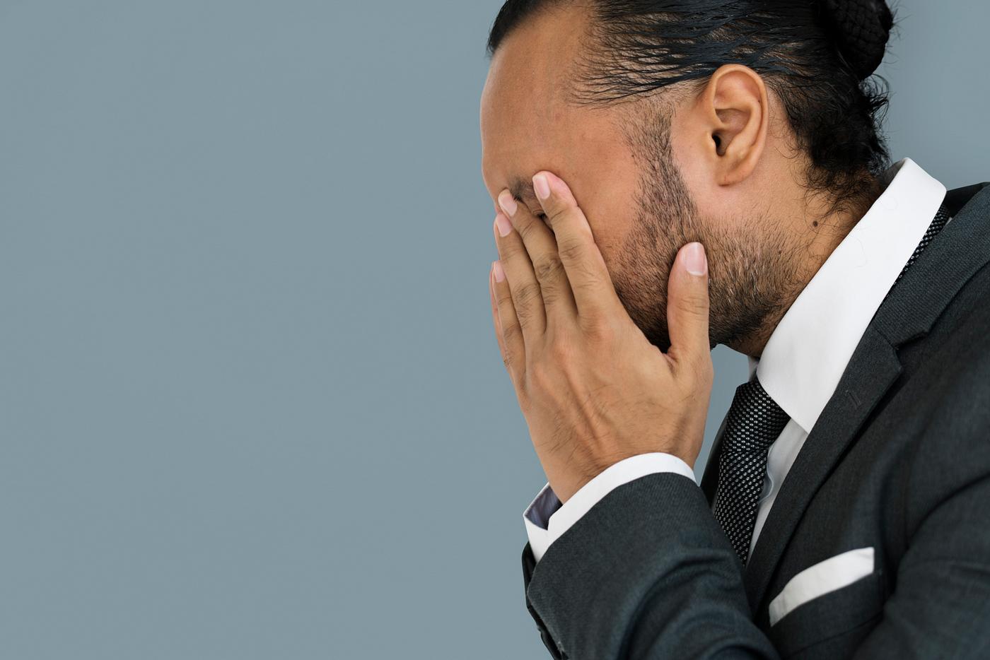 Stressed man rubbing his eyes Stressed man rubbing his eyes