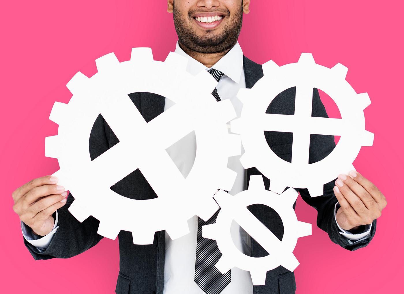 studio, progress, expression, person, holding, people, teamwork, gear, pink, smile, cheerful, smiling, isolated, connection... studio, progress, expression, person, holding, people, teamwork, gear, pink, smile, cheerful, smiling, isolated, connection...