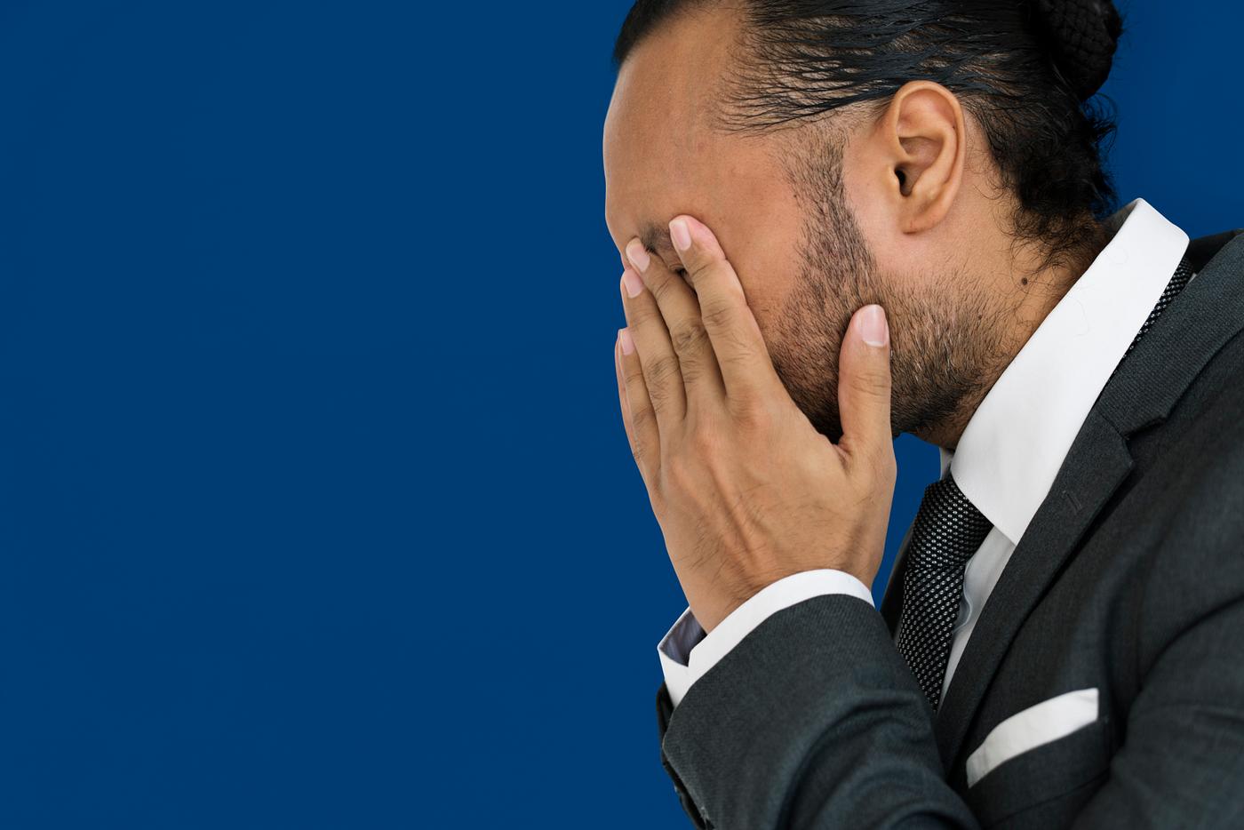 Stressed man rubbing his eyes Stressed man rubbing his eyes