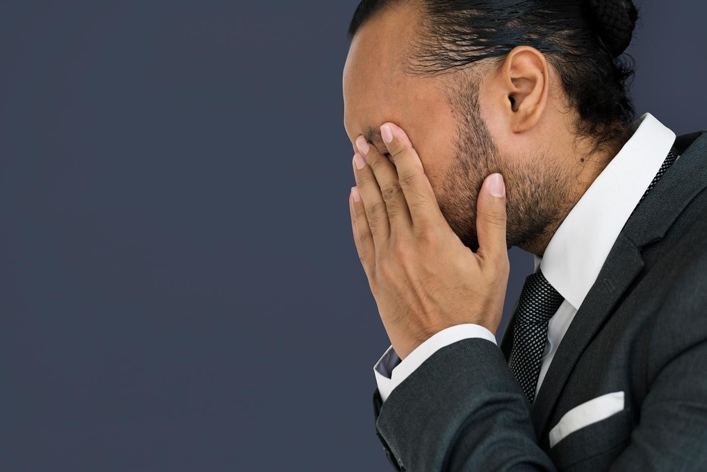 Stressed man rubbing his eyes - adult, background, blue, business, closed, disappointed, ethnicity, expression, face, female... Stressed man rubbing his eyes - adult, background, blue, business, closed, disappointed, ethnicity, expression, face, female...