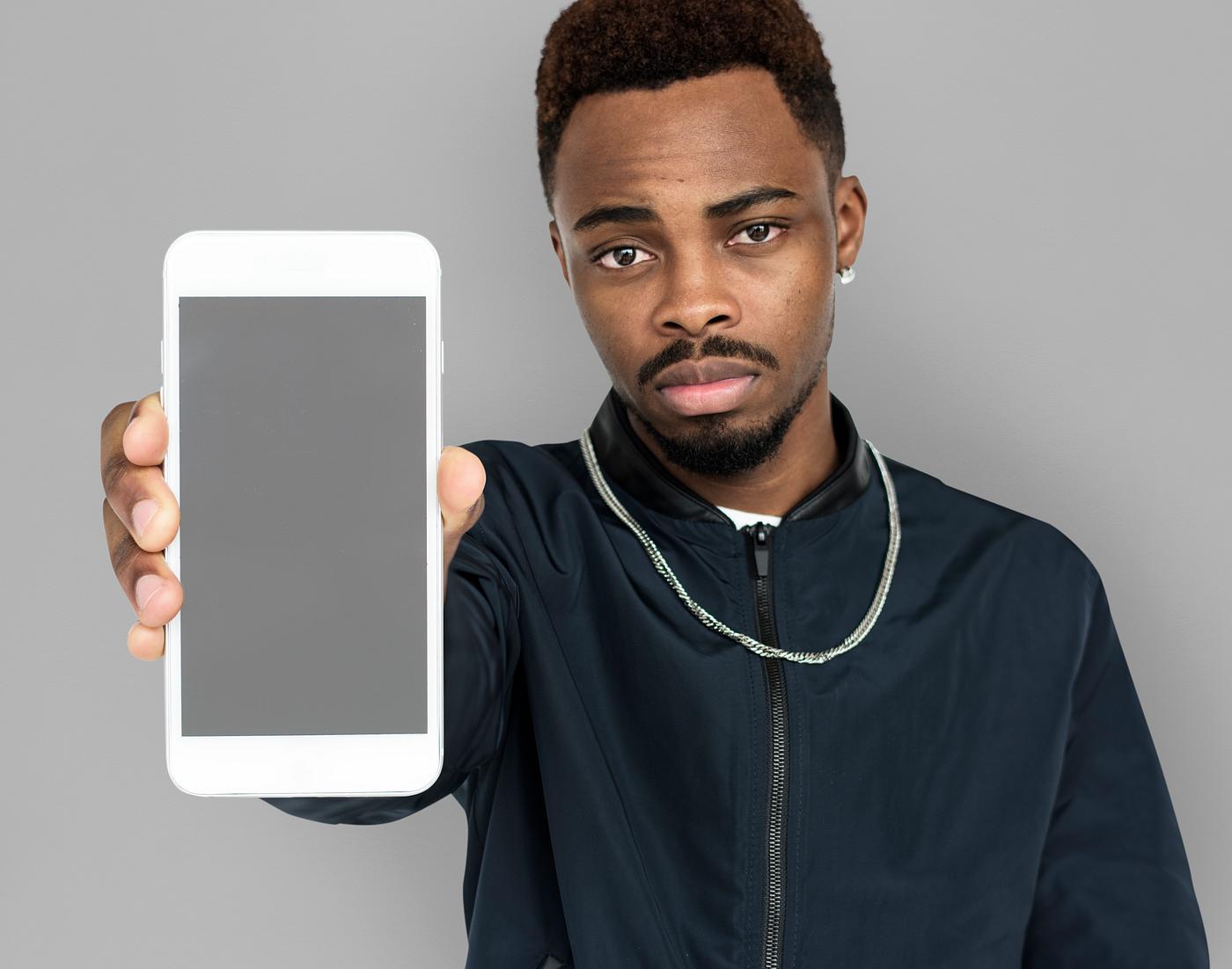 african descent, background, beard, black, communication, device, emotion, expression, focused, grey, holding, holding phone... african descent, background, beard, black, communication, device, emotion, expression, focused, grey, holding, holding phone...