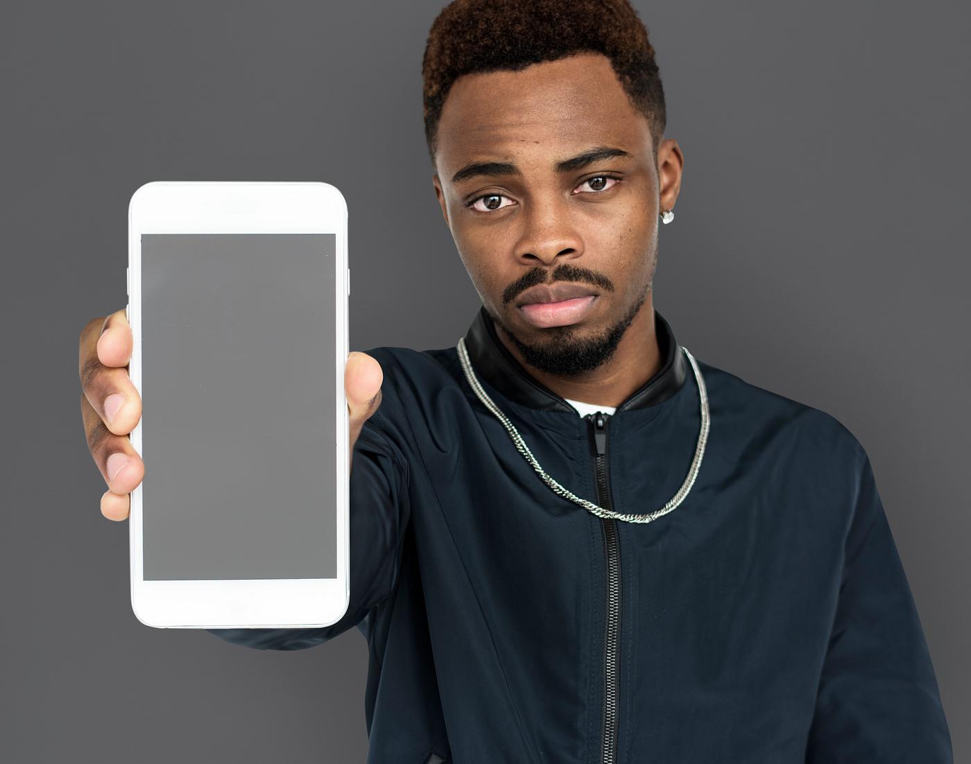 african descent, background, beard, black, communication, device, emotion, expression, focused, grey, holding, holding phone... african descent, background, beard, black, communication, device, emotion, expression, focused, grey, holding, holding phone...