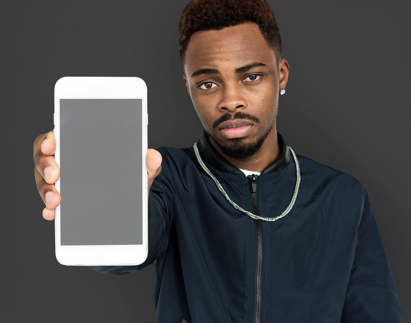 african descent, background, beard, black, communication, device, emotion, expression, focused, grey, holding, holding phone... african descent, background, beard, black, communication, device, emotion, expression, focused, grey, holding, holding phone...