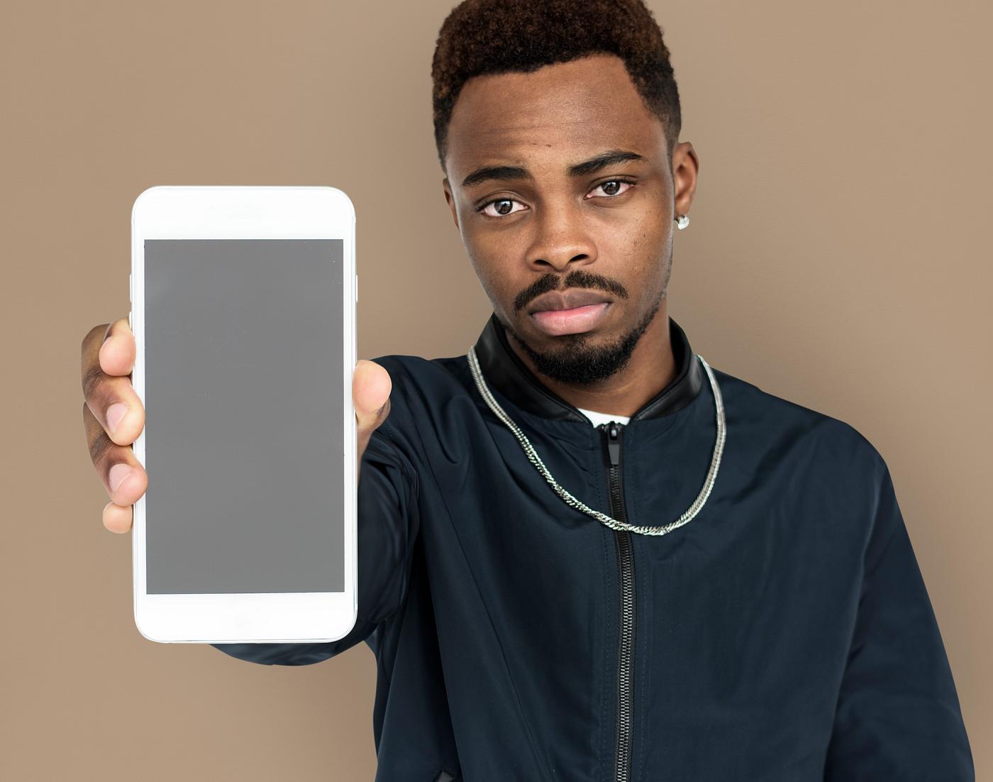 african descent, background, beard, black, brown, communication, device, emotion, expression, focused, holding, holding... african descent, background, beard, black, brown, communication, device, emotion, expression, focused, holding, holding...