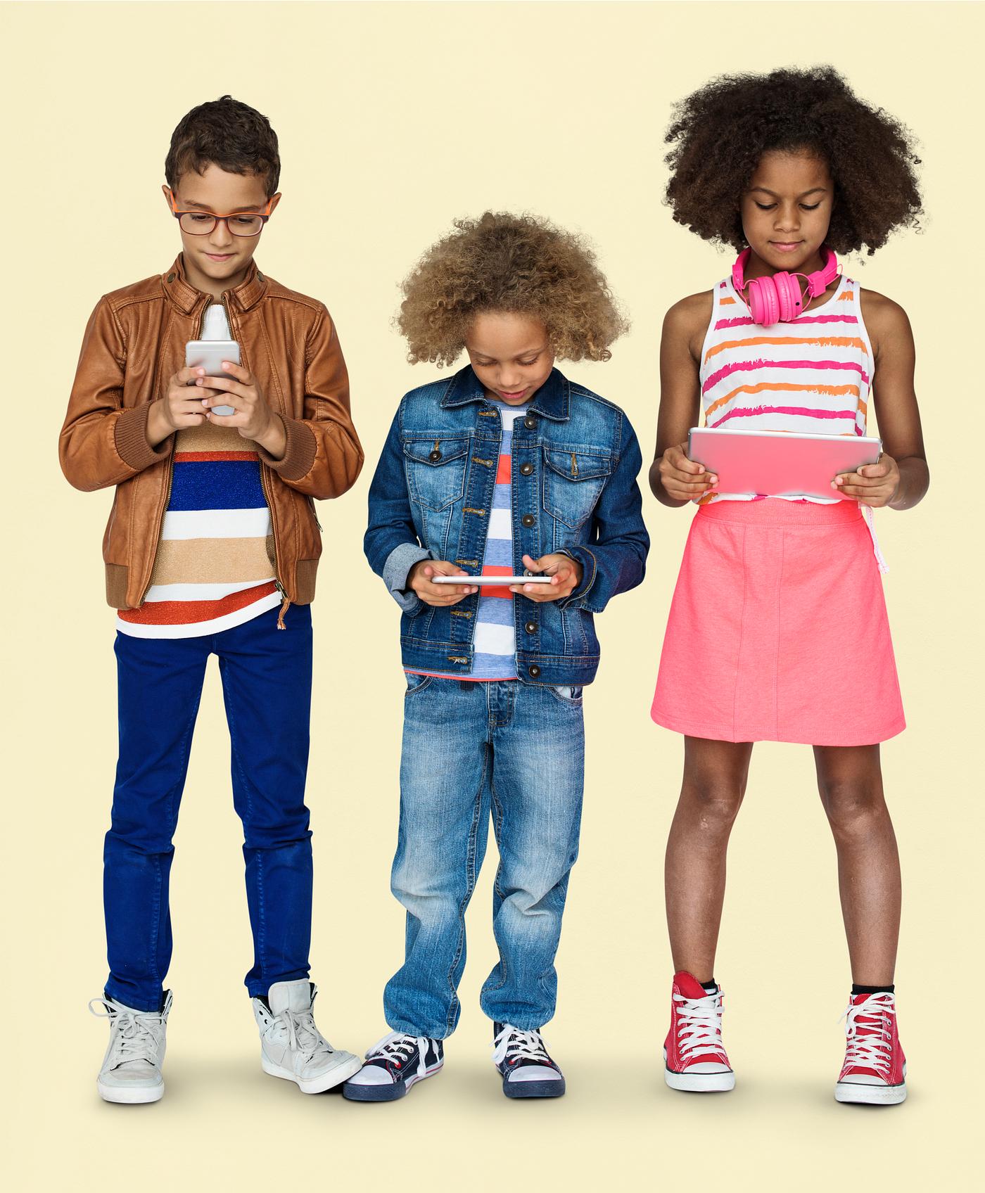Kids using their digital devices - studio, expression, phone, person, technology, little, children, concentrating, focusing... Kids using their digital devices - studio, expression, phone, person, technology, little, children, concentrating, focusing...