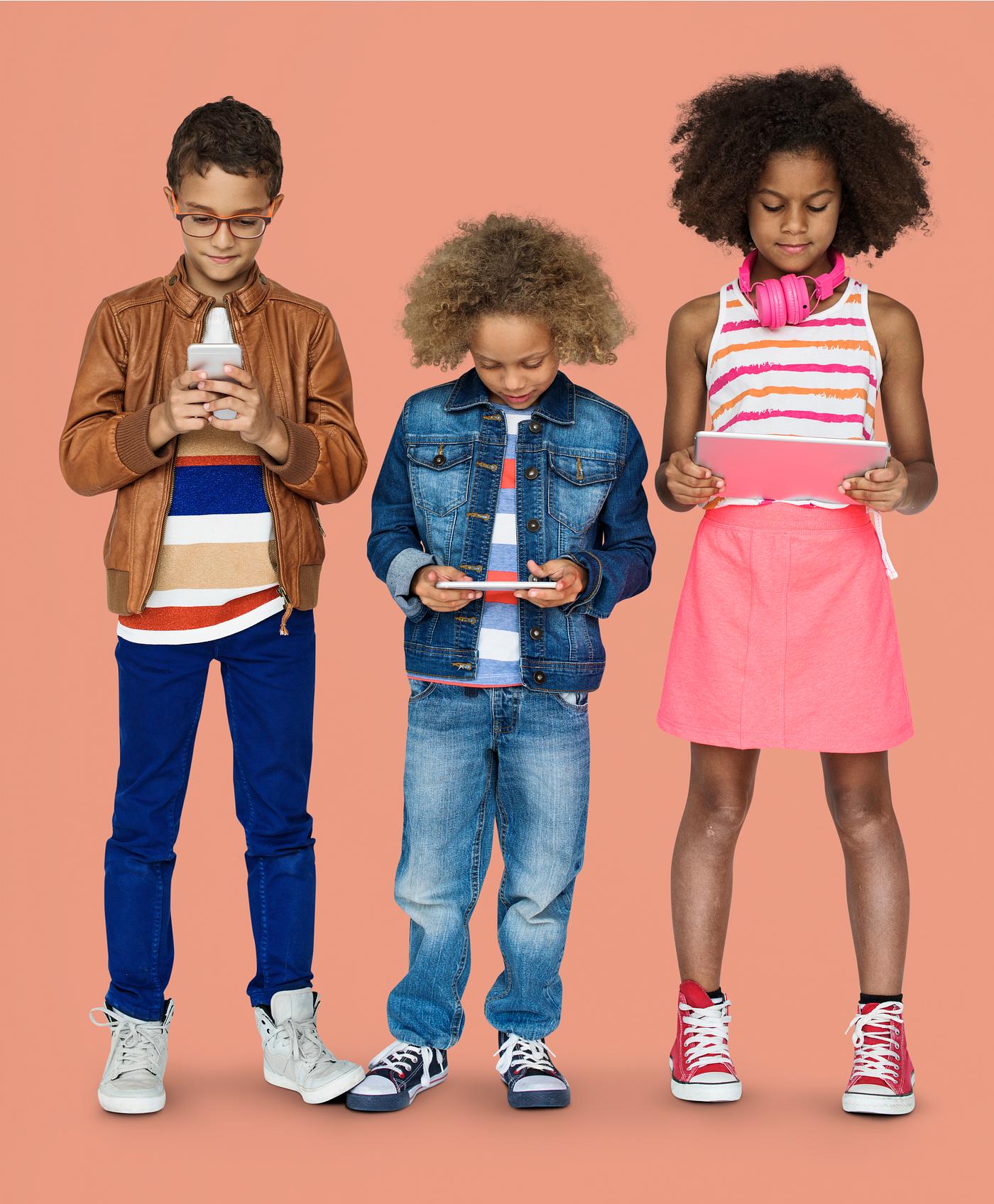 Kids using their digital devices - studio, expression, phone, person, technology, little, children, concentrating, focusing... Kids using their digital devices - studio, expression, phone, person, technology, little, children, concentrating, focusing...