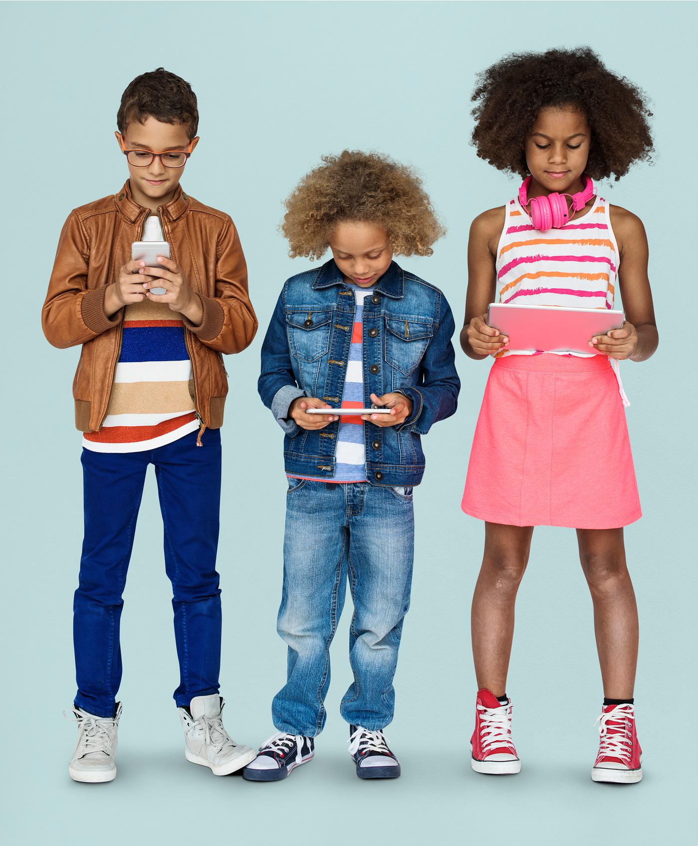 Cool kids using phones and tablets Cool kids using phones and tablets