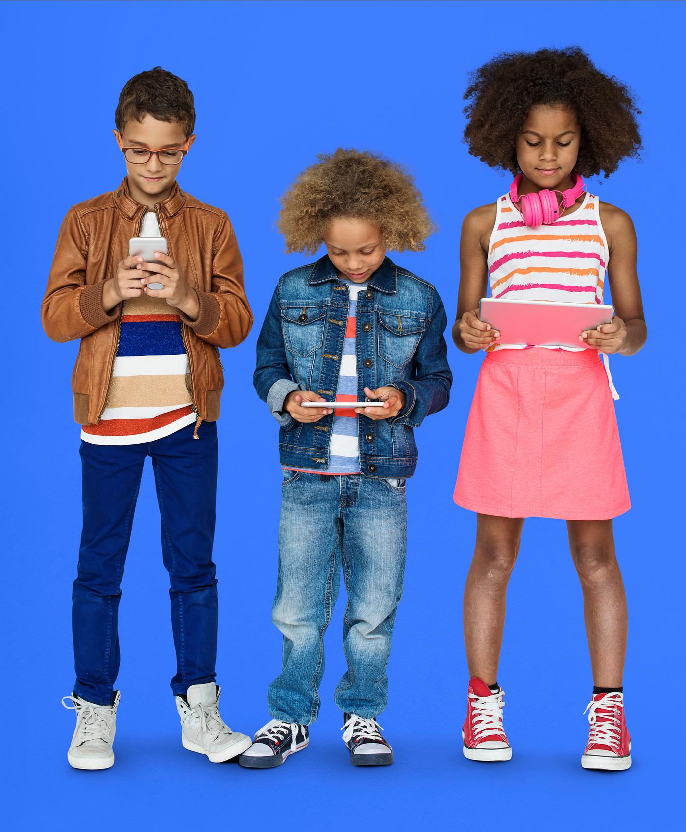 Kids using their digital devices - studio, expression, phone, person, technology, little, children, concentrating, focusing... Kids using their digital devices - studio, expression, phone, person, technology, little, children, concentrating, focusing...