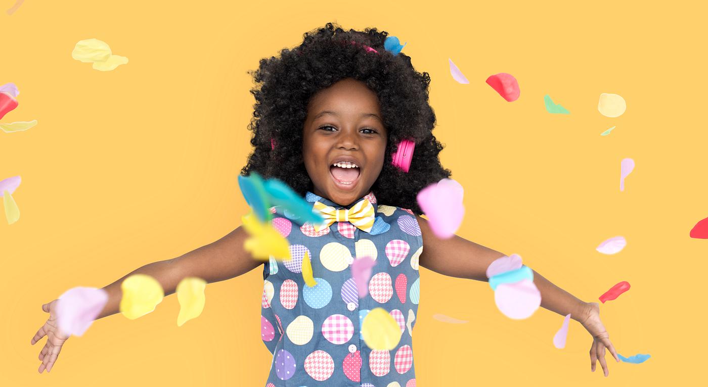 Girl with an afro enjoying colorful confetti Girl with an afro enjoying colorful confetti