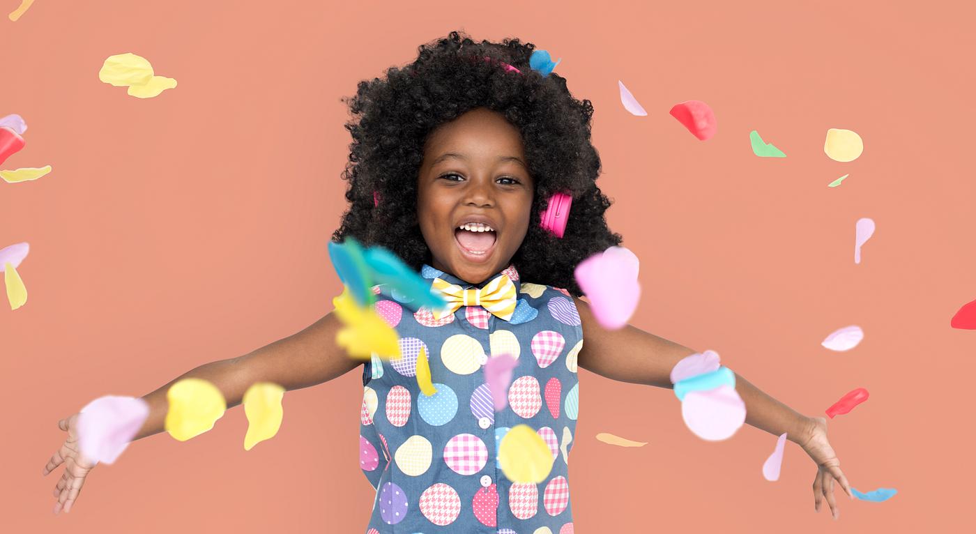 Girl with an afro enjoying colorful confetti Girl with an afro enjoying colorful confetti