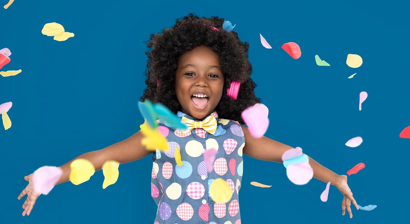 Girl with an afro enjoying colorful confetti Girl with an afro enjoying colorful confetti