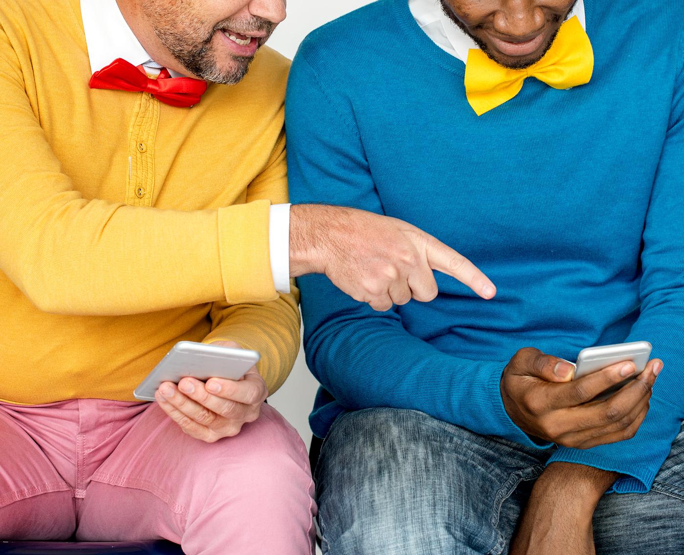 Two colorful men and their phones Two colorful men and their phones