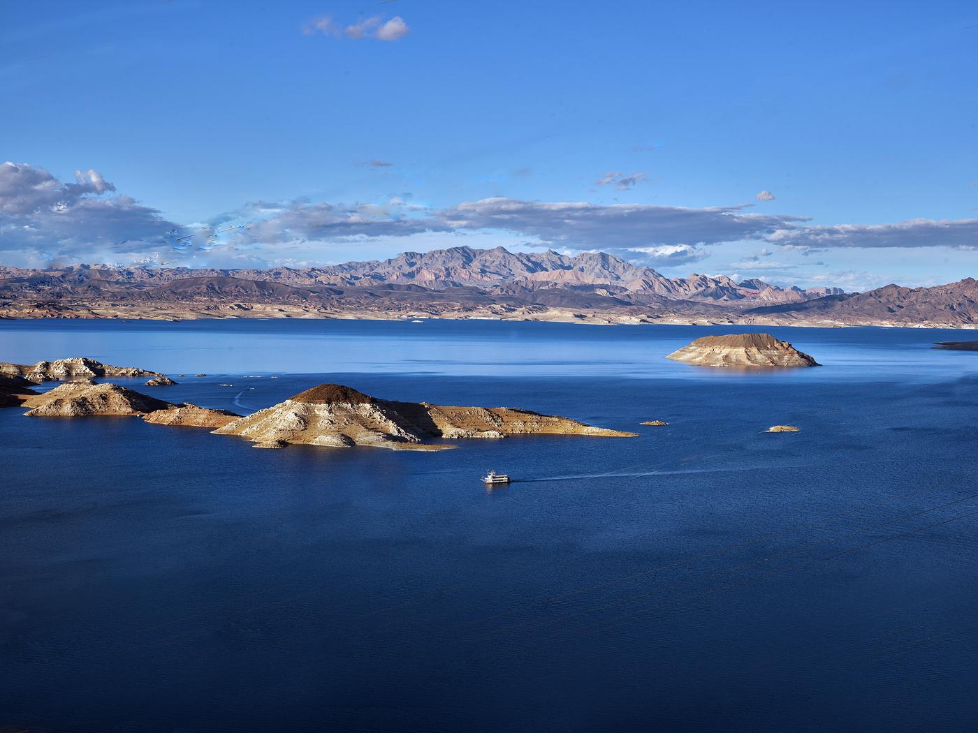 Aerial view of a portion the water and surroundings of Lake Mead, created by the construction of nearby Hoover Dam, which... Aerial view of a portion the water and surroundings of Lake Mead, created by the construction of nearby Hoover Dam, which...
