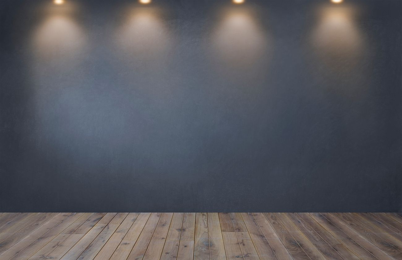 Dark gray wall with a row of spotlights in an empty room | Royalty free