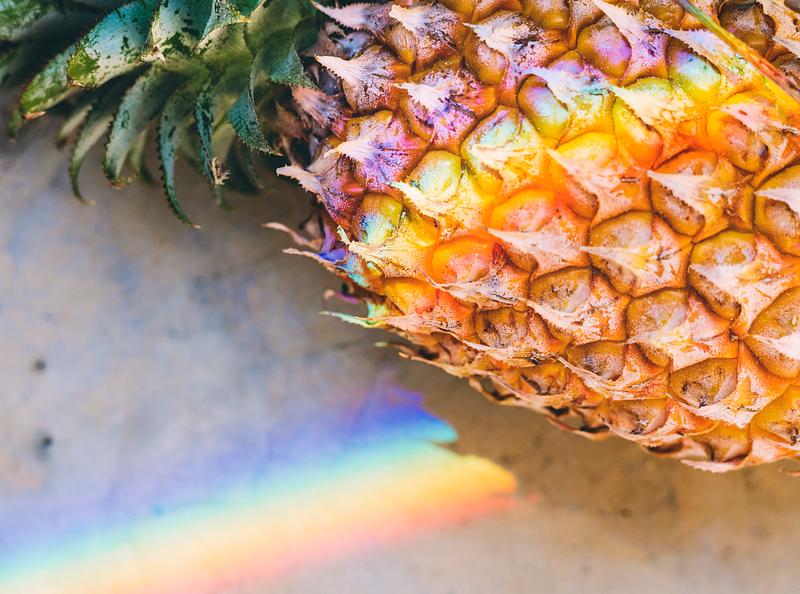 Closeup of fresh pineapple with rainbow prism light Closeup of fresh pineapple with rainbow prism light
