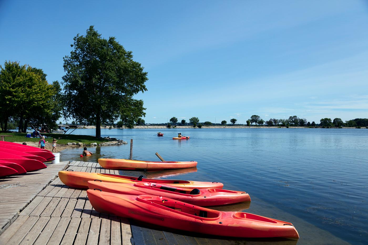 Bright-red canoes at Brittingham Park's beach on Lake Monona in Madison, Wisconsin's capital city. Original image... Bright-red canoes at Brittingham Park's beach on Lake Monona in Madison, Wisconsin's capital city. Original image...