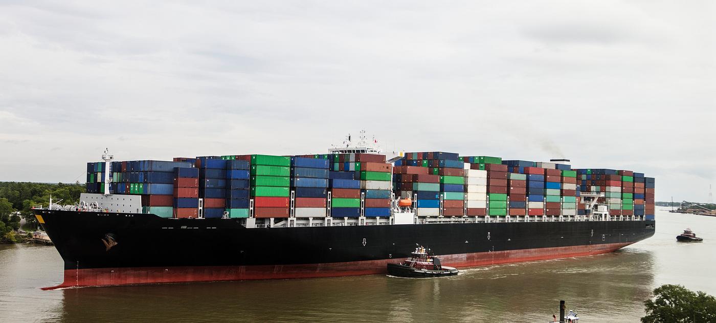 With a tugboat's help, an exceptionally heavy-laden oceangoing container ship plies the busy Savannah River in Savannah... With a tugboat's help, an exceptionally heavy-laden oceangoing container ship plies the busy Savannah River in Savannah...
