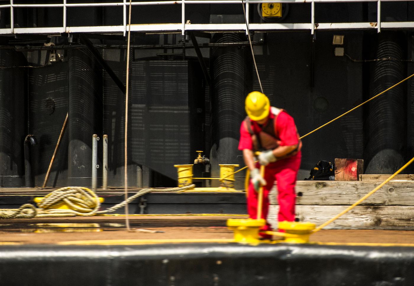Workers control support ropes from the space shuttle Enterprise to lift it off of a barge and onto the Intrepid Sea, Air and... Workers control support ropes from the space shuttle Enterprise to lift it off of a barge and onto the Intrepid Sea, Air and...