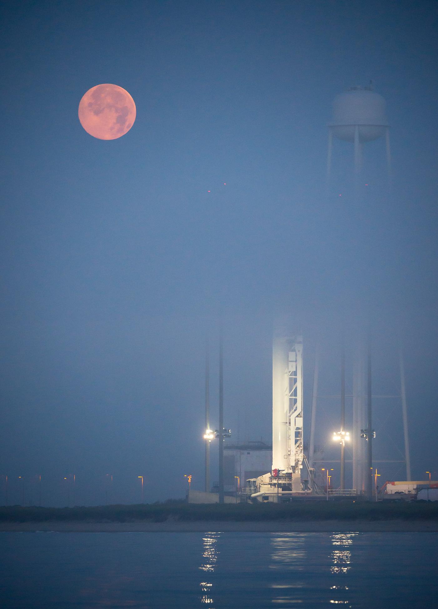 The full Moon sets in the fog behind the Orbital Sciences Corporation Antares rocket. Original from NASA. Digitally enhanced... The full Moon sets in the fog behind the Orbital Sciences Corporation Antares rocket. Original from NASA. Digitally enhanced...