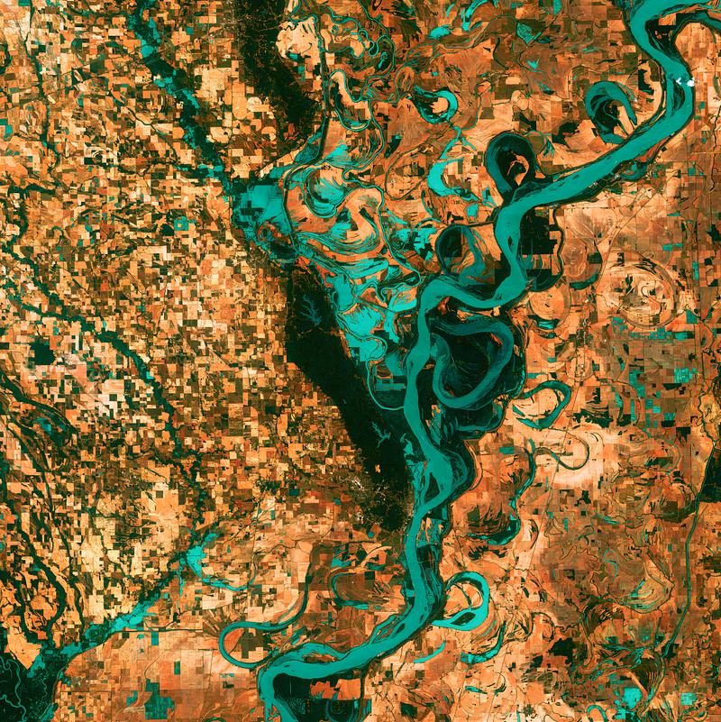 Small, blocky shapes of towns, fields, and pastures surround the graceful swirls and whorls of the Mississippi River. Original from NASA. Digitally enhanced by rawpixel. Small, blocky shapes of towns, fields, and pastures surround the graceful swirls and whorls of the Mississippi River.…