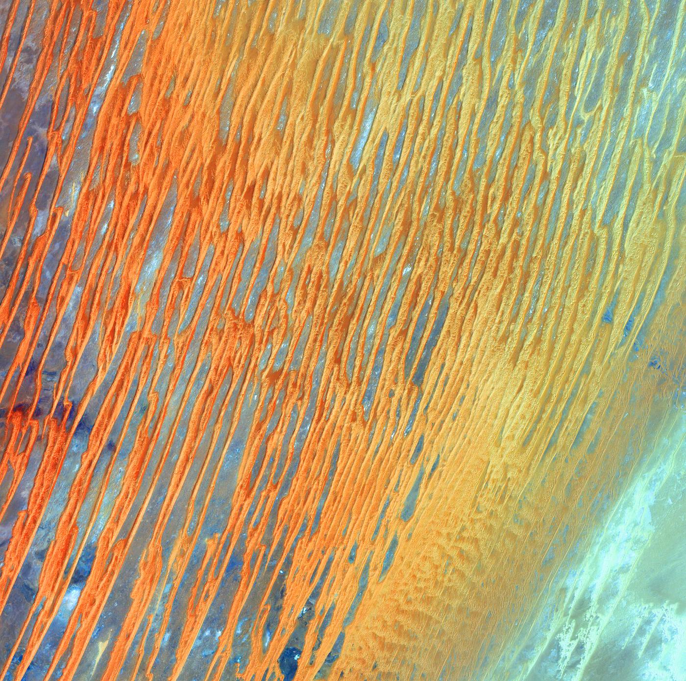 Ribbons of Saharan sand dunes seem to glow in sunset colors. Original from NASA. Digitally enhanced by rawpixel. Ribbons of Saharan sand dunes seem to glow in sunset colors. Original from NASA. Digitally enhanced by rawpixel.