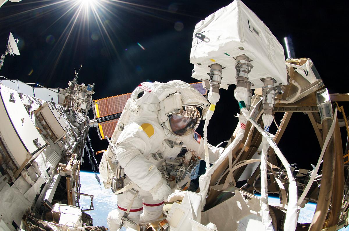 Astronauts working outside the space… | Free public domain photo Astronauts working outside the space station's Quest airlock in Oct 7, 2014. Original from NASA. Digitally enhanced by…