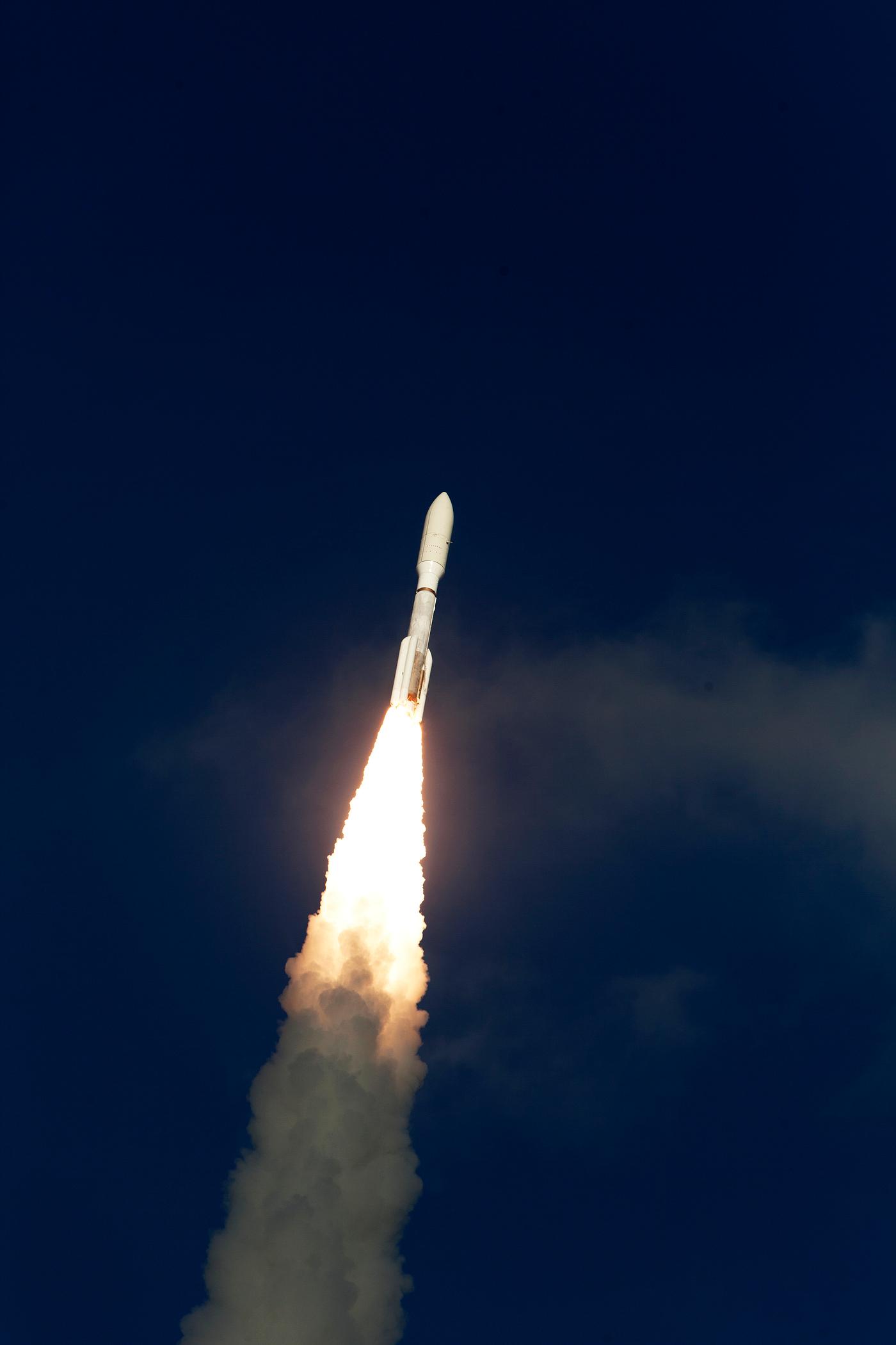 Rising from fire and smoke, NASA's Juno planetary probe, enclosed in its payload fairing, launches atop a United Launch... Rising from fire and smoke, NASA's Juno planetary probe, enclosed in its payload fairing, launches atop a United Launch...