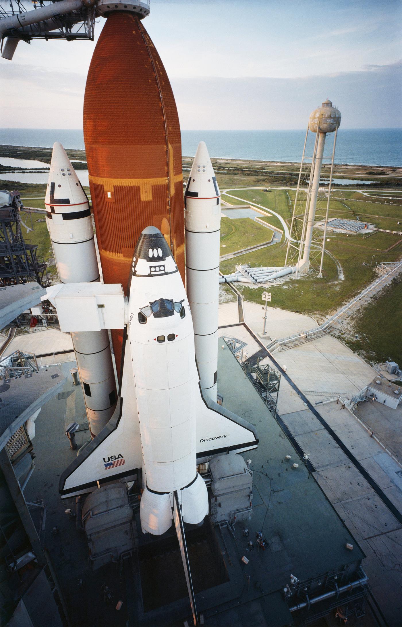 Orbiter Discovery is poised on Launch Pad 39A as the sun sets the evening prior to its maiden launch. Original from NASA.... Orbiter Discovery is poised on Launch Pad 39A as the sun sets the evening prior to its maiden launch. Original from NASA....