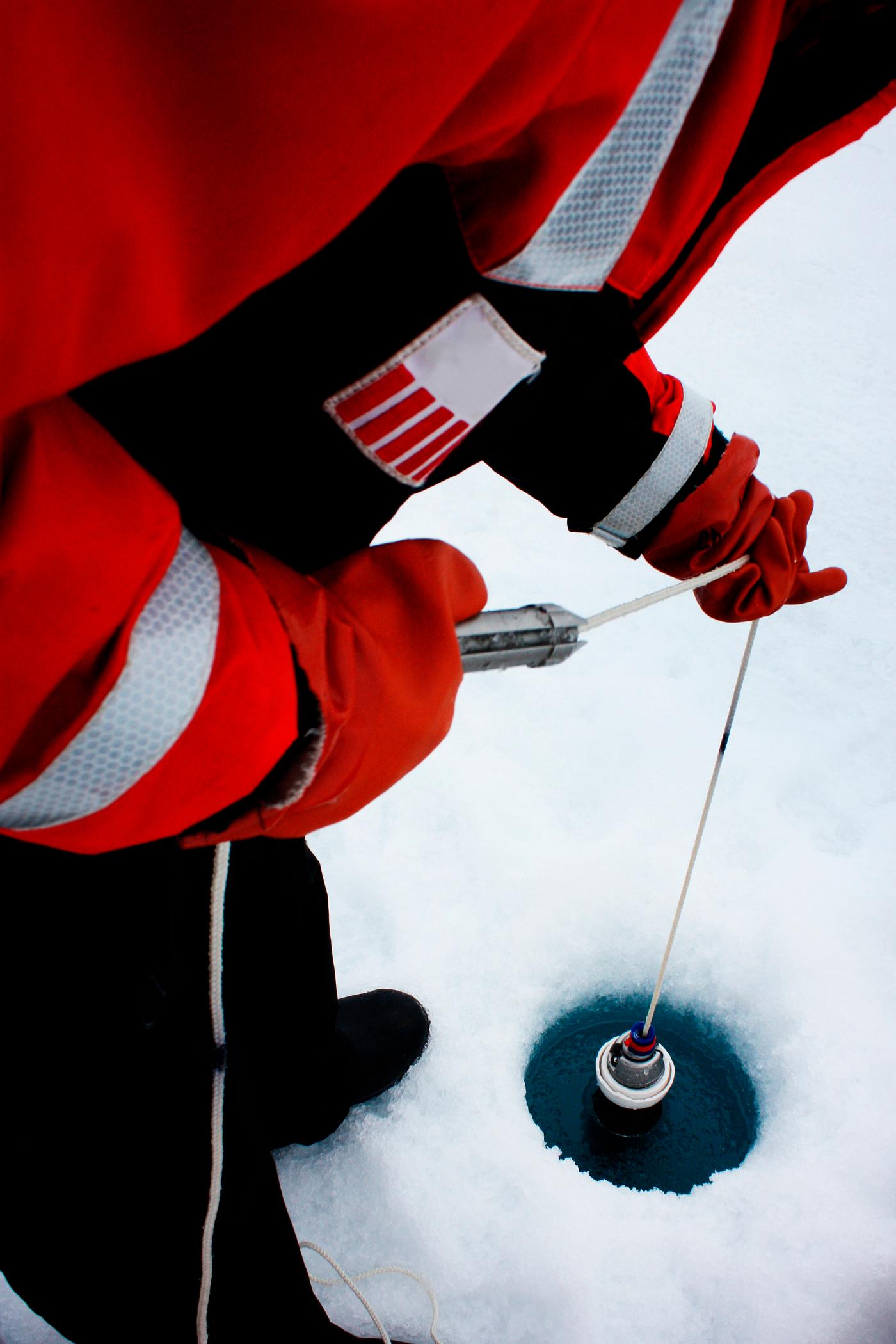 Clark University student Christie Wood lowers a water sampler into a borehole on July 4, 2010. Original from NASA. Digitally... Clark University student Christie Wood lowers a water sampler into a borehole on July 4, 2010. Original from NASA. Digitally...