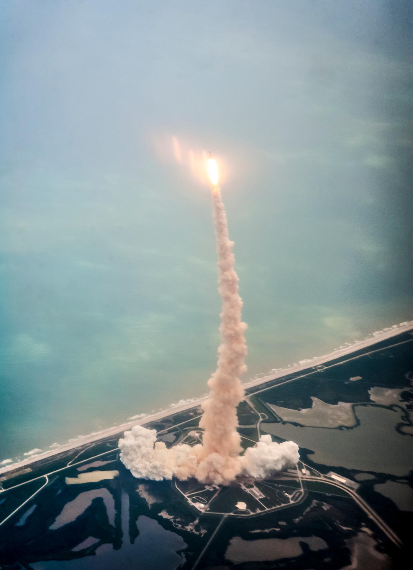 Space shuttle Atlantis is seen through the window of a Shuttle Training Aircraft (STA) as it launches from launch pad 39A at... Space shuttle Atlantis is seen through the window of a Shuttle Training Aircraft (STA) as it launches from launch pad 39A at...