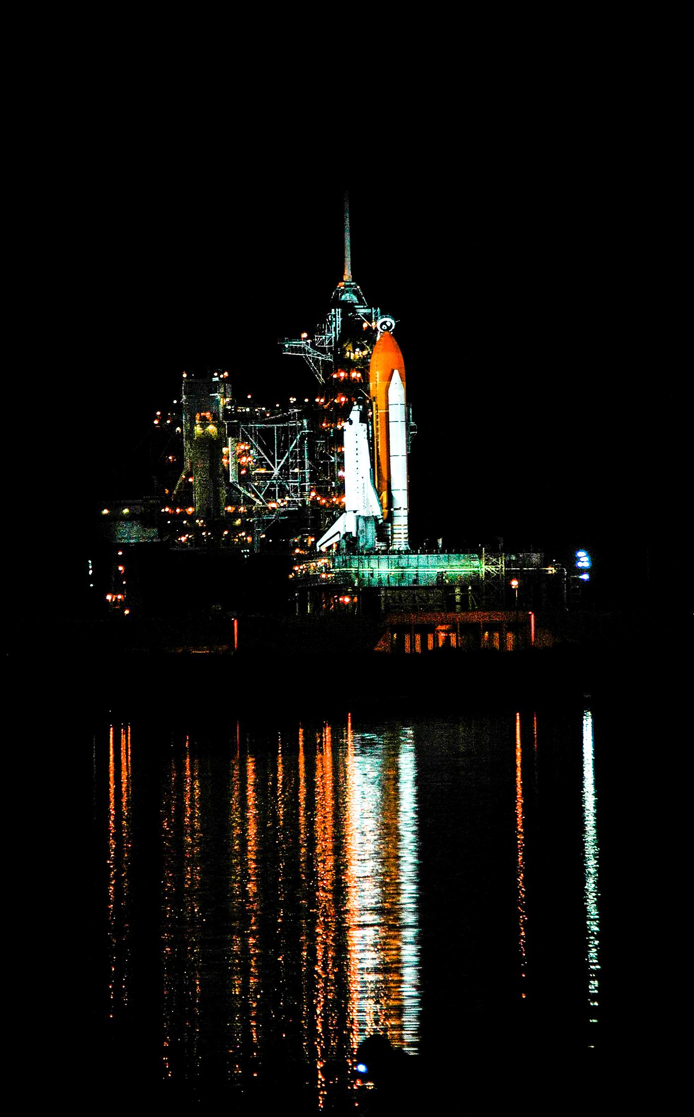 Space shuttle Atlantis, attached to its bright-orange external fuel tank and twin solid rocket boosters on Launch Pad 39A at... Space shuttle Atlantis, attached to its bright-orange external fuel tank and twin solid rocket boosters on Launch Pad 39A at...