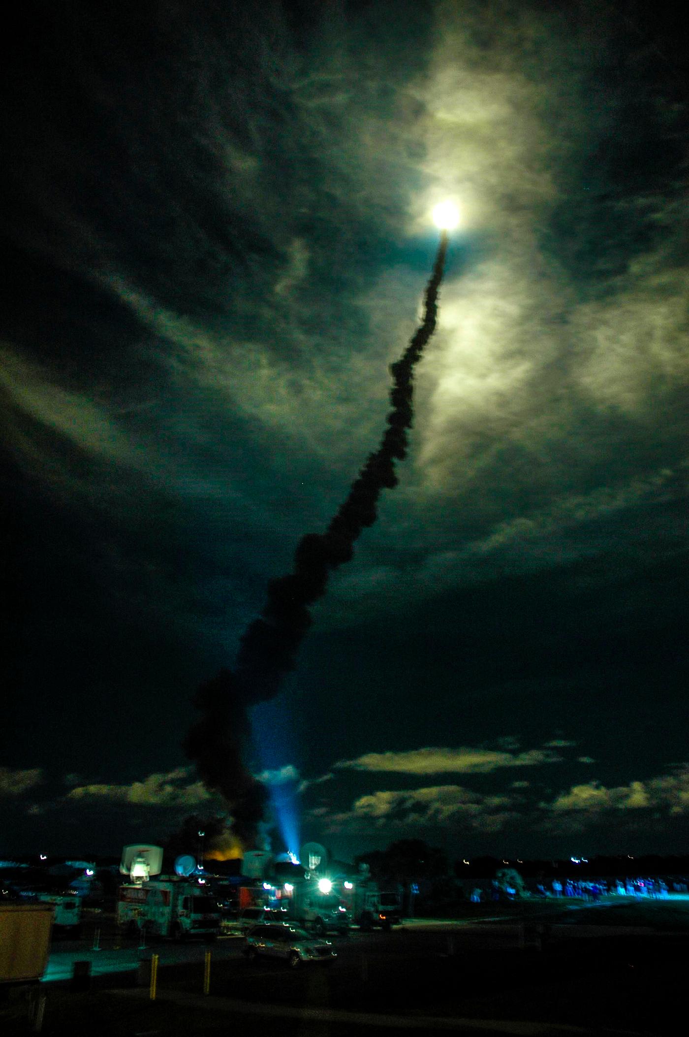 Flooding the night sky with light, Space Shuttle Discovery streaks through the clouds after liftoff from Launch Pad 39B on... Flooding the night sky with light, Space Shuttle Discovery streaks through the clouds after liftoff from Launch Pad 39B on...