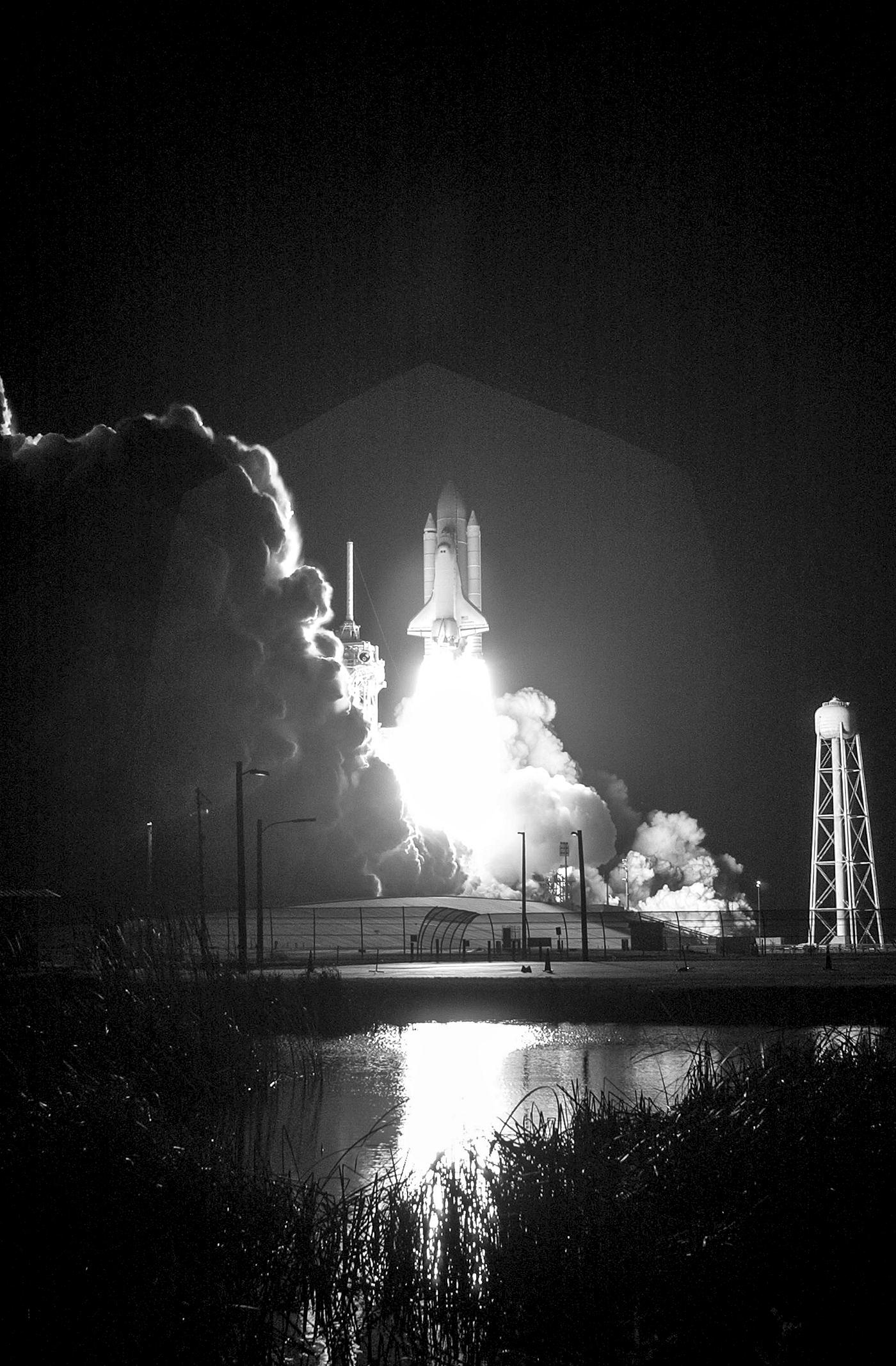 At liftoff from Launch Pad 39B, Space Shuttle Discovery spreads a blaze of light as it leaps into the night sky over Kennedy... At liftoff from Launch Pad 39B, Space Shuttle Discovery spreads a blaze of light as it leaps into the night sky over Kennedy...