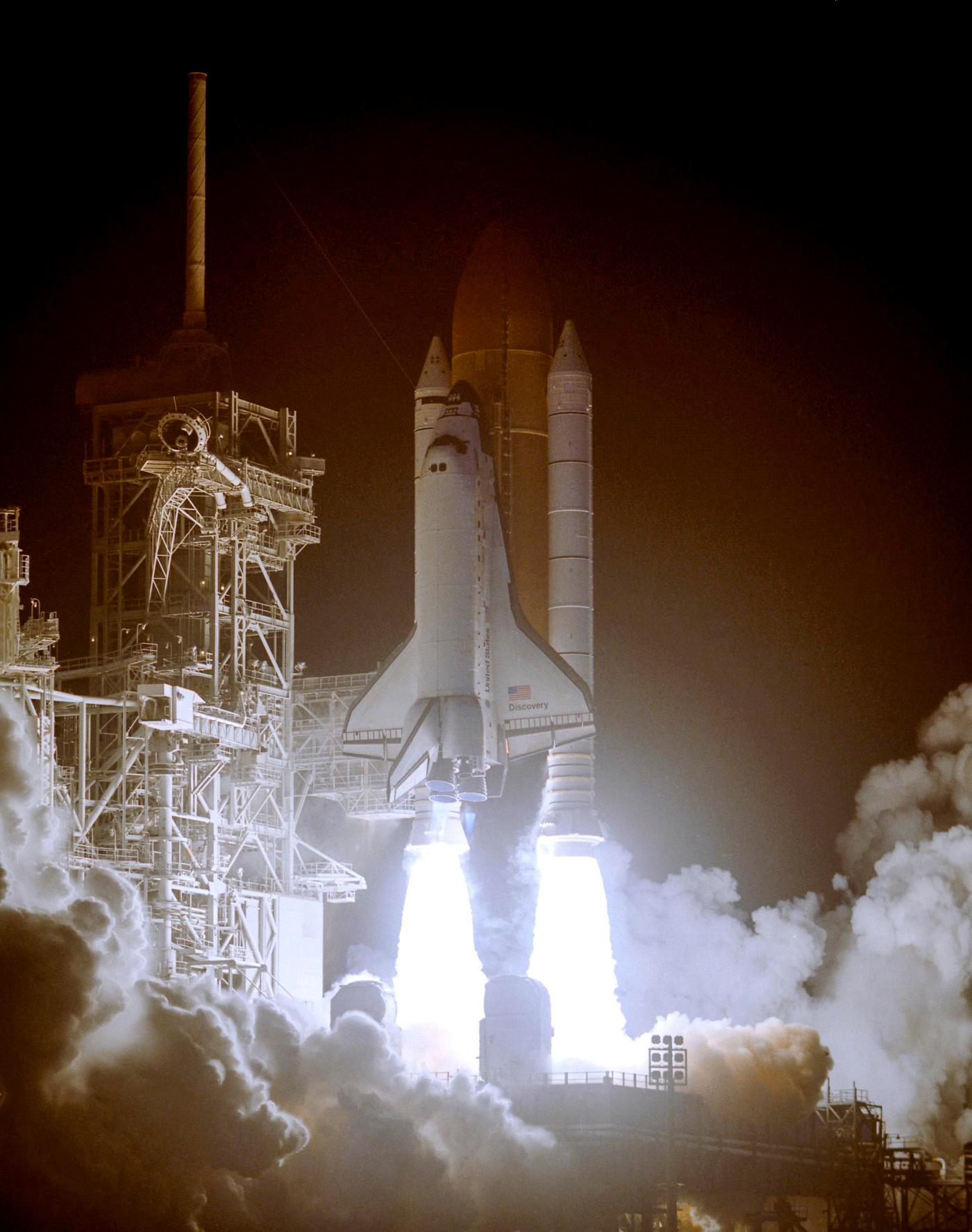 Space shuttle Discover standing on the fiery columns erupting from the solid rocket boosters as it lifts off Launch Pad 39B... Space shuttle Discover standing on the fiery columns erupting from the solid rocket boosters as it lifts off Launch Pad 39B...