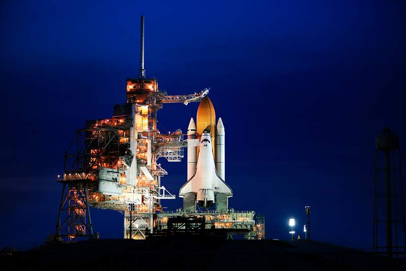 Space shuttle Atlantis, attached to its bright-orange external fuel tank and twin solid rocket boosters on Launch Pad 39A at NASA's Kennedy Space Center in Florida. Original from NASA. Digitally enhanced by rawpixel. Space shuttle Atlantis, attached to its bright-orange external fuel tank and twin solid rocket boosters on Launch Pad 39A at…