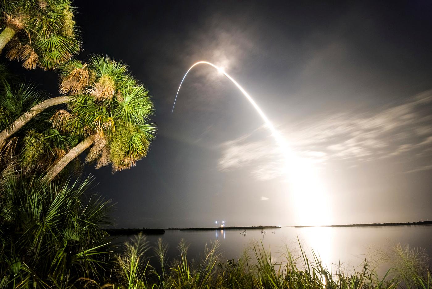 Viewed from the Banana River Viewing Site at NASA's Kennedy Space Center in Florida, space shuttle Discovery arcs... Viewed from the Banana River Viewing Site at NASA's Kennedy Space Center in Florida, space shuttle Discovery arcs...