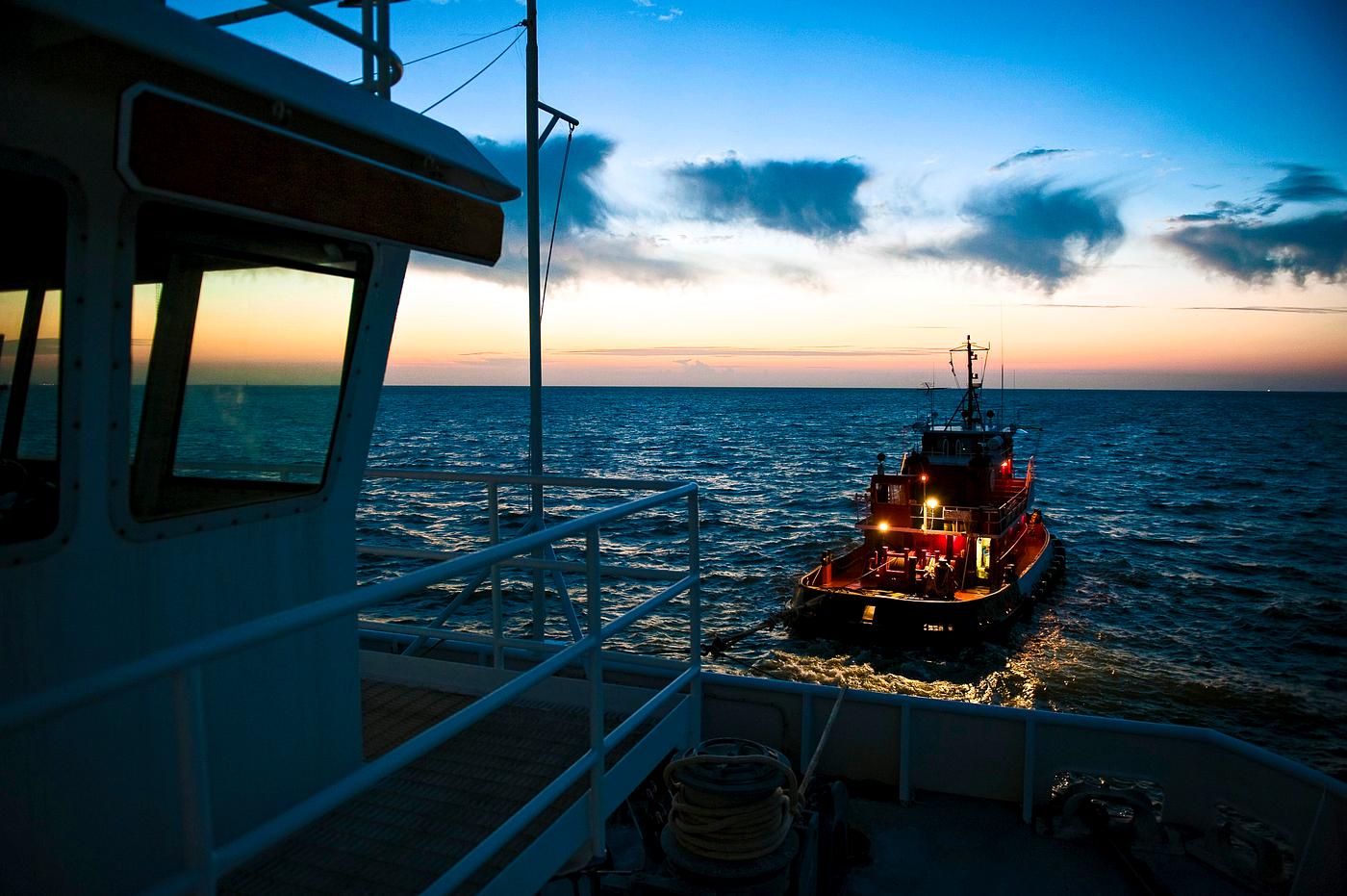 A tug boat pulls the Pegasus Barge carrying the Space Shuttle Program's last external fuel tank, ET-122, from NASA's... A tug boat pulls the Pegasus Barge carrying the Space Shuttle Program's last external fuel tank, ET-122, from NASA's...