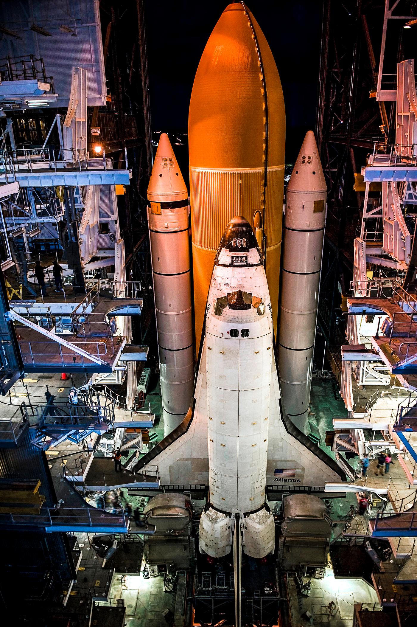 Space shuttle Atlantis, attached to its bright-orange external fuel tank and twin solid rocket boosters on Launch Pad 39A at... Space shuttle Atlantis, attached to its bright-orange external fuel tank and twin solid rocket boosters on Launch Pad 39A at...