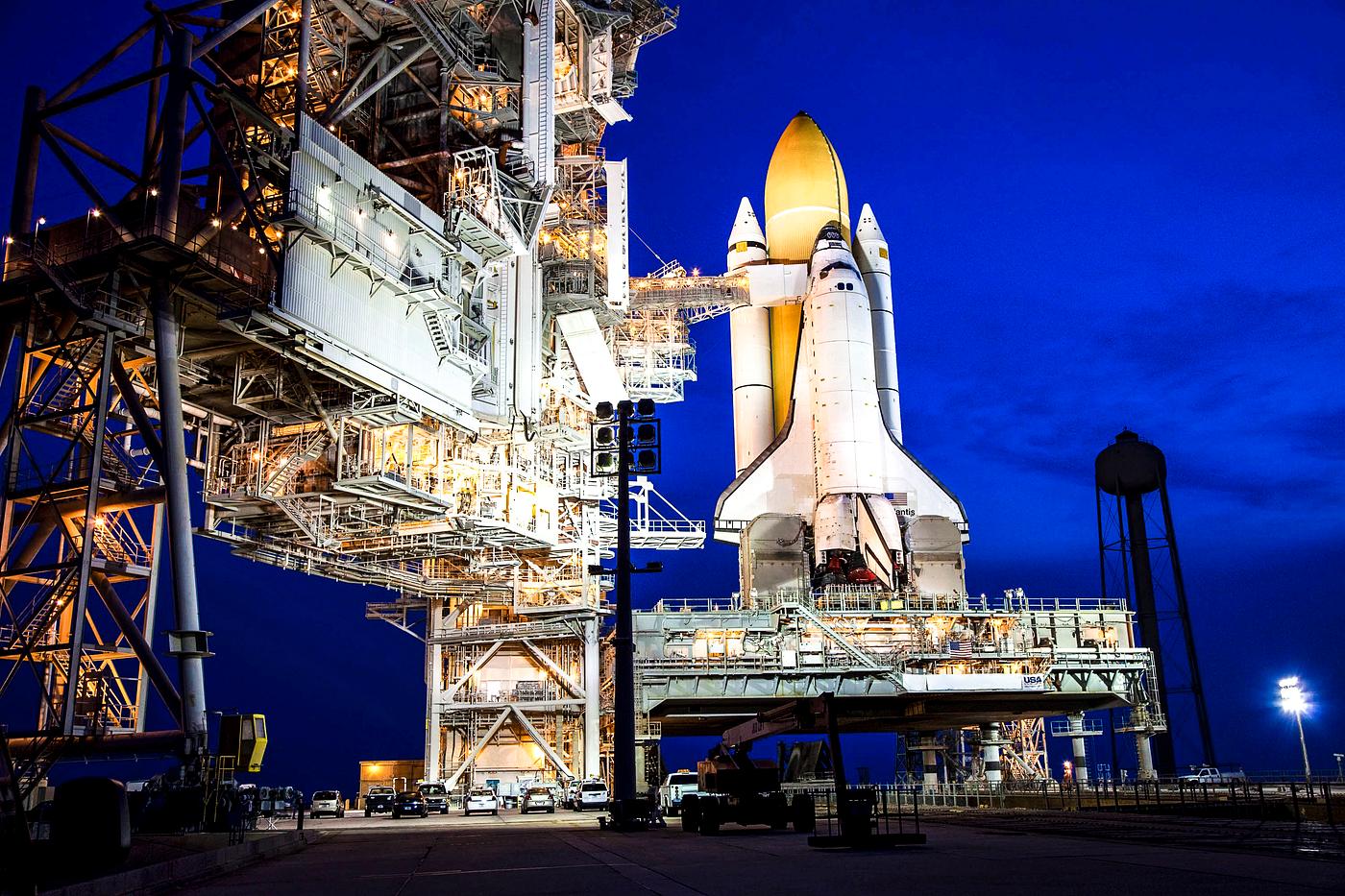 Space shuttle Atlantis, attached to its bright-orange external fuel tank and twin solid rocket boosters on Launch Pad 39A at... Space shuttle Atlantis, attached to its bright-orange external fuel tank and twin solid rocket boosters on Launch Pad 39A at...
